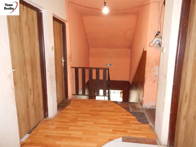 A floor with a wooden decor and stairs in a family house.