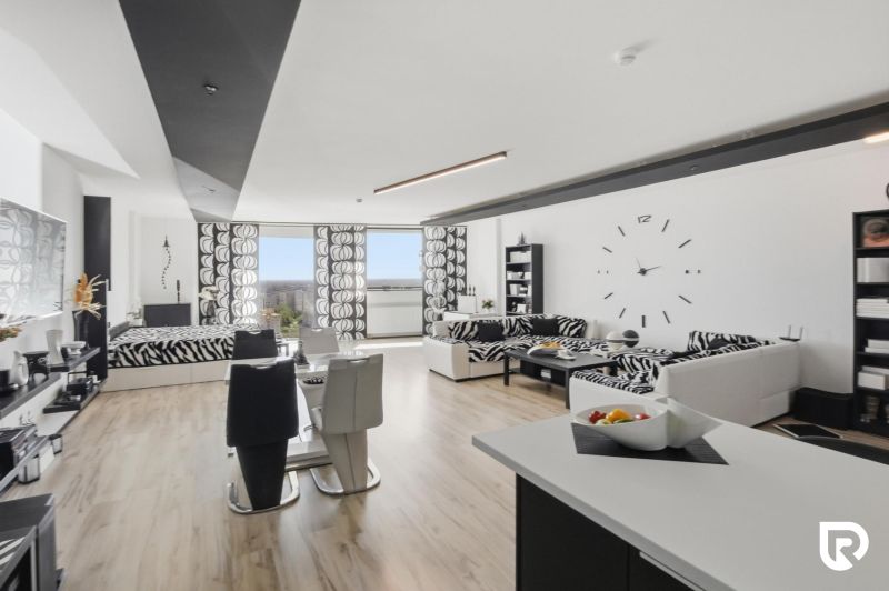 Living room in a two-room apartment with zebra patterns and a wooden decor floor.