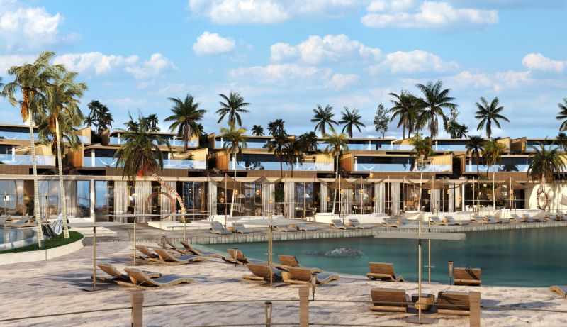 Palm trees and loungers by the beach in Nungwi, in front of the resort with palm trees.