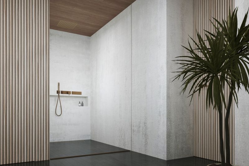 A minimalist bathroom in a villa with a wooden ceiling and a plant.