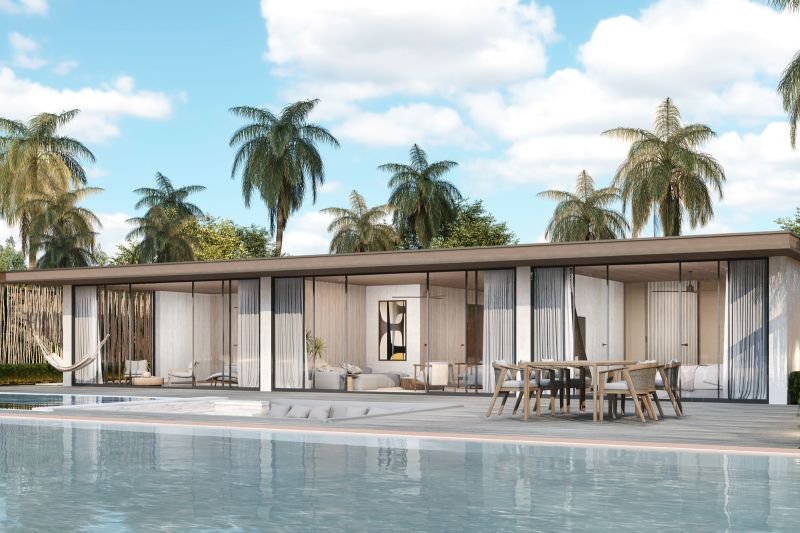 Exterior of a 1-bedroom apartment in Nungwi with a pool and palm trees in the background.