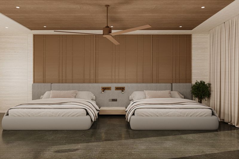 A bedroom with two beds, a ceiling fan, and a wooden decor floor in a villa.