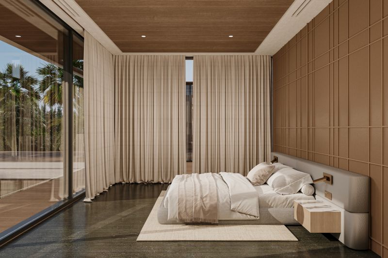 Bedroom in a villa with large windows, wooden decor flooring, and a palm view.