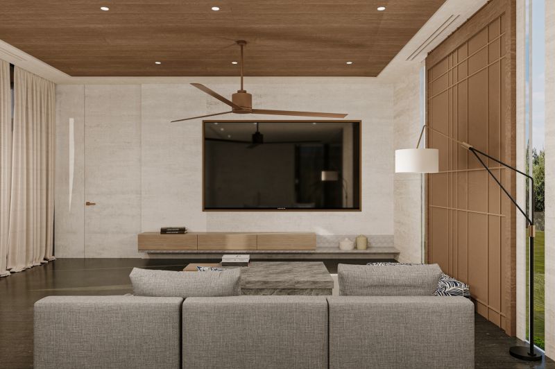 Living room of the villa with a sofa, television, and wooden decor flooring.