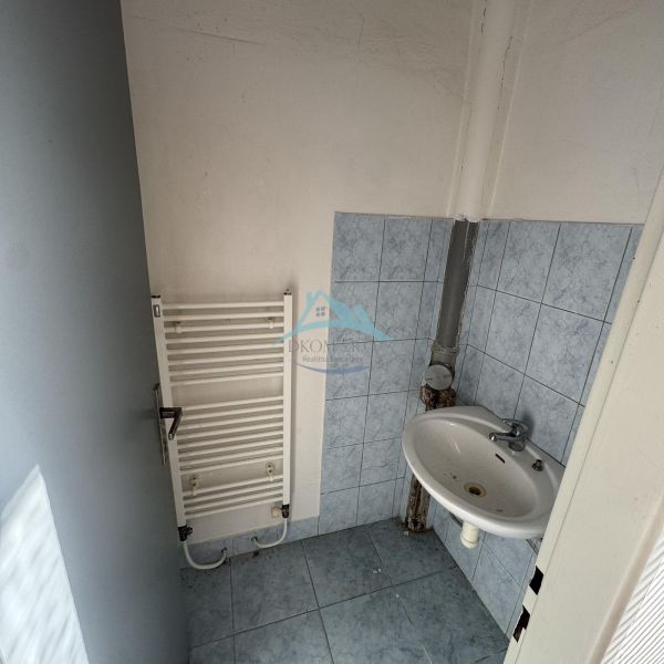Bathroom with a sink and central heating in commercial premises.