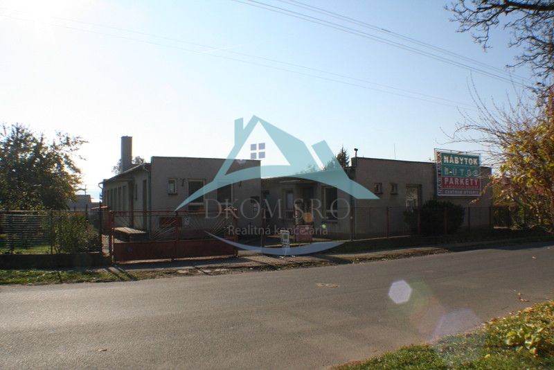 Commercial premises on Ľudovíta Štúra in Šahy, a building with advertising signs, asphalt road.