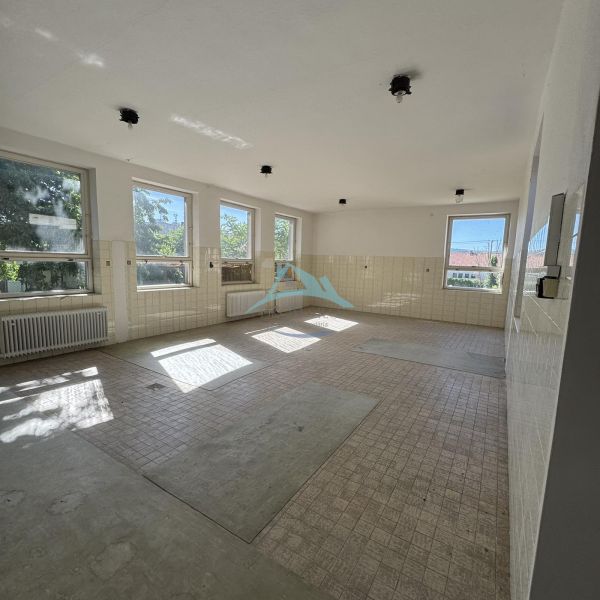 Spacious commercial spaces with tiling and large windows for natural lighting.