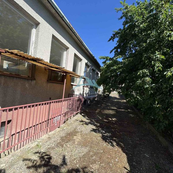 Commercial premises on Ľudovíta Štúra Street in Šahy, with surrounding trees shading the road.