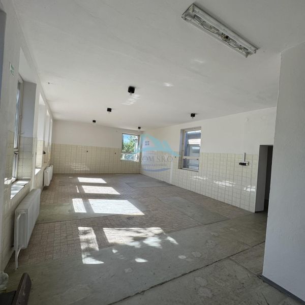 Bright interior of commercial spaces with large windows and ceramic tiles.