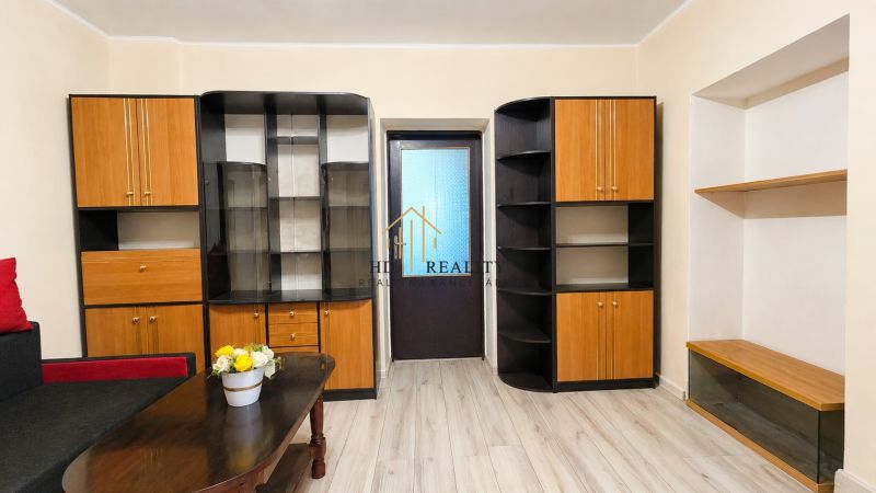 Living room in a family house with furniture and a decorative floor with a wooden design.