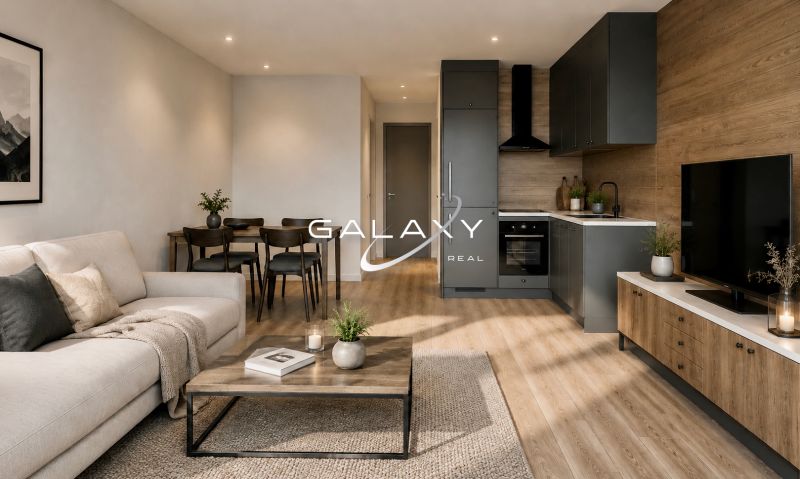 Living room with kitchen in a holiday apartment, wooden decor flooring, simple furniture.