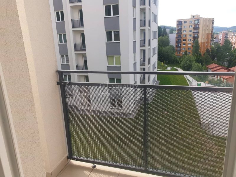 View from the balcony of a 1-room apartment on Žarec Street in Čadca, visible are apartment buildings.