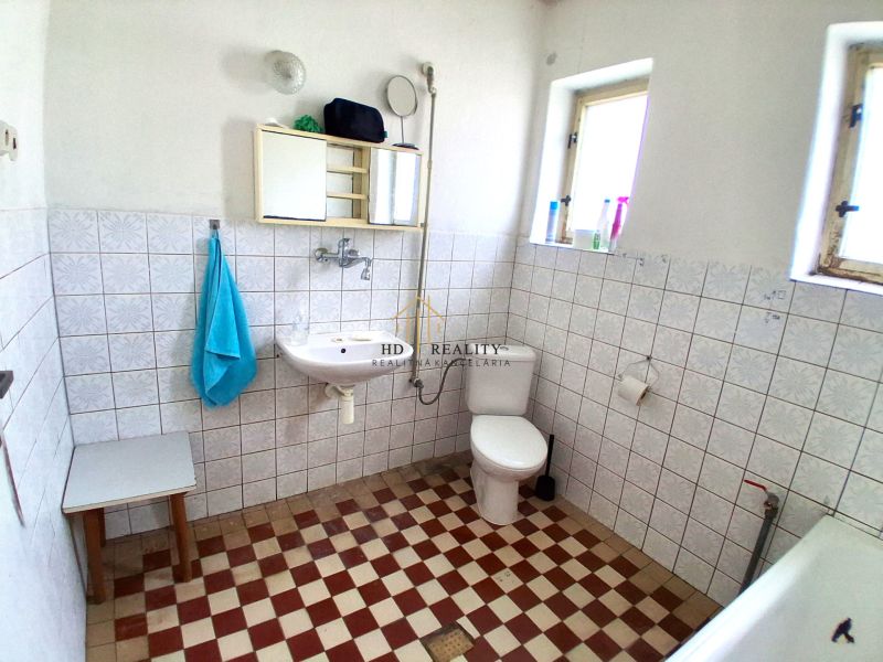 Bathroom in a family house with tiles and classic equipment.