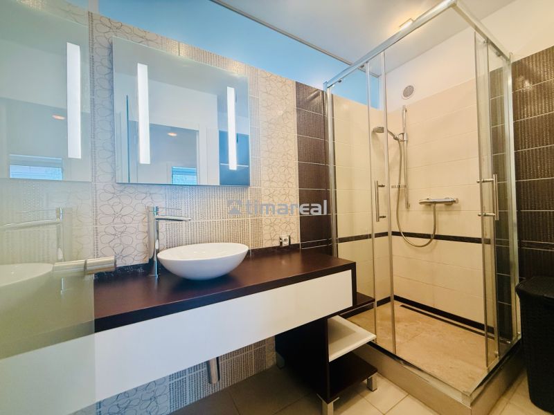 A bathroom in a 3-room apartment with a sink and a shower.