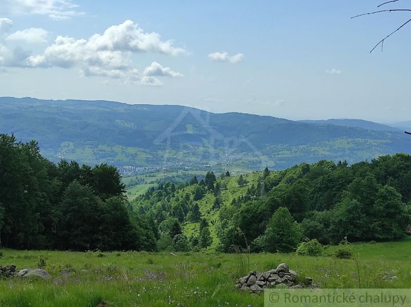 A breathtaking panorama of Hriňová from Záhrady, bordered by forests and hills on the horizon.