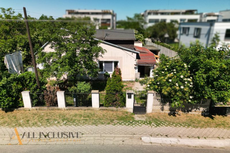 A family house in the area of Dunajská Lužná, surrounded by greenery and adjacent residential plots.