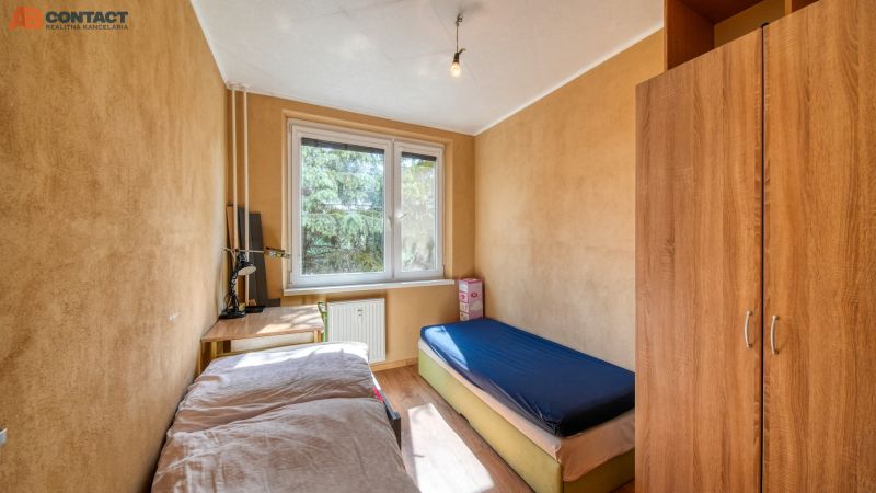 A room with light furniture, a table, and a bed in a 4-room apartment.