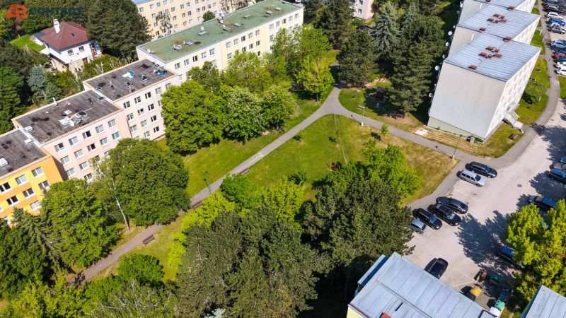 View of Viestova Street with apartment buildings and greenery in Myjava, ideal for a 4-room apartment.
