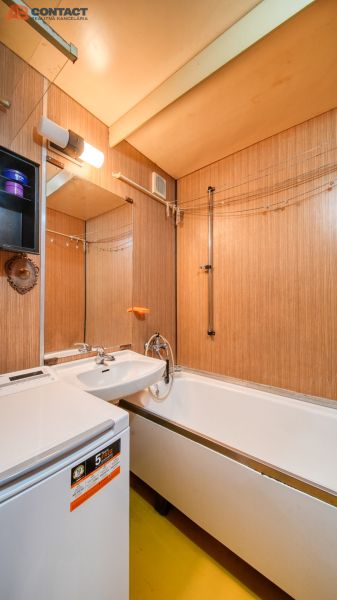 A bathroom with a shower, a bathtub, and storage space in a 4-room apartment.