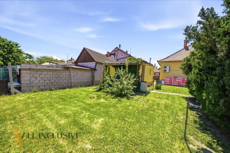 A well-maintained garden at a family house in Dunajská Streda with lush greenery and trees.