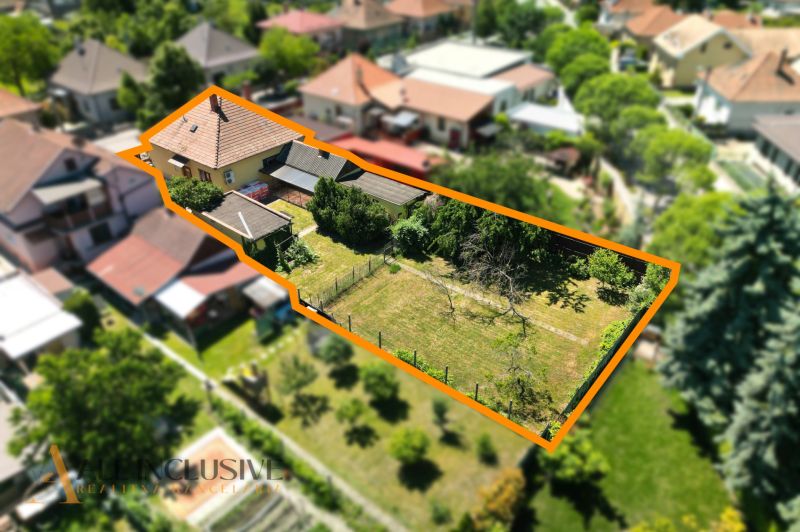 A family house in Dunajská Streda with a large plot of land and sparse vegetation.