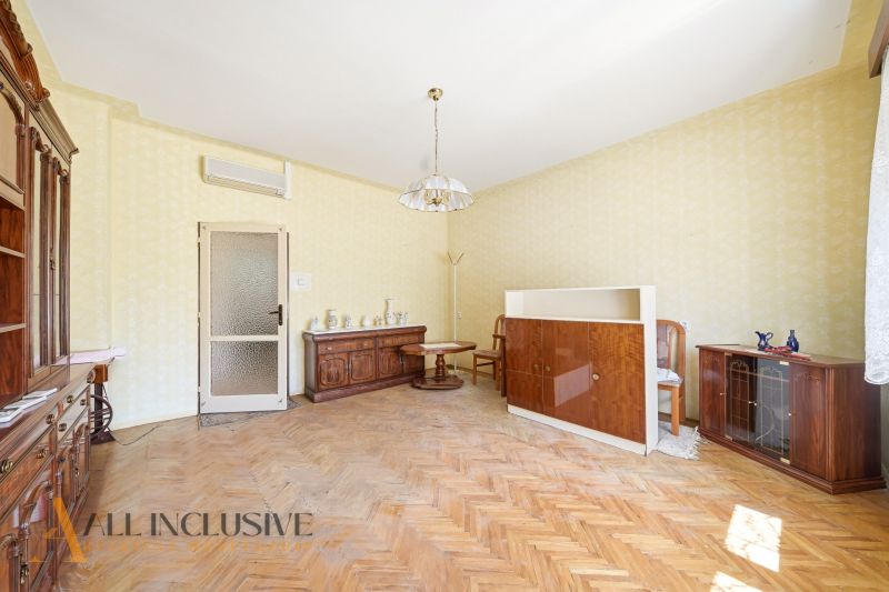 A living room in a family house with wooden decor and classic style furniture.