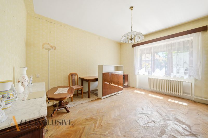 A room in a family house with a wooden decor floor, furnished in retro style.