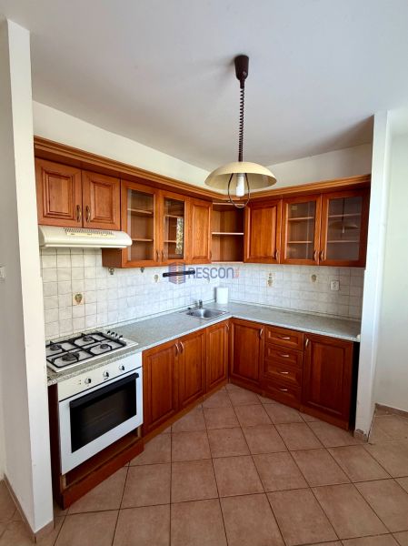 A kitchen with a corner kitchen unit, wooden cabinets, and a gas stove in a 4-room apartment.