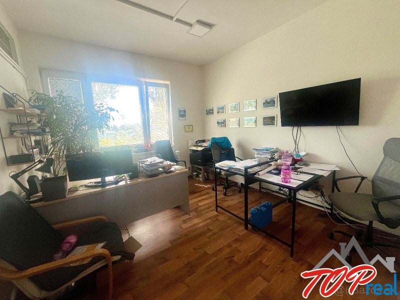 Interior of commercial spaces with offices, wooden decor flooring, table, chairs.
