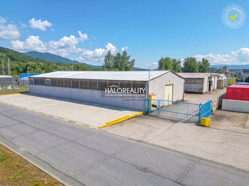 Production premises in Považská Bystrica with extensive outdoor parking and surrounding greenery.