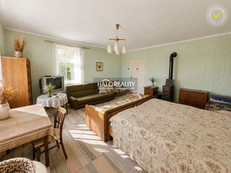 Interior of a family house with furniture, a tiled stove, and a bed, a room in pleasant colors.