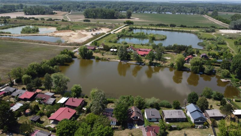 Cottages in Kopčany by the lake and surrounding nature, also visible are other bodies of water.