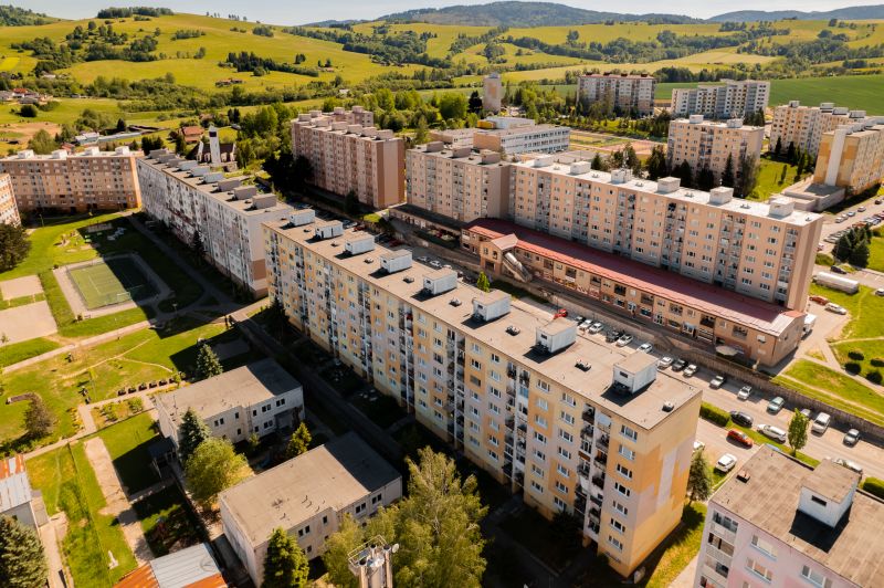 View of the housing estate on 9th May Street in Brezno with surrounding greenery.
