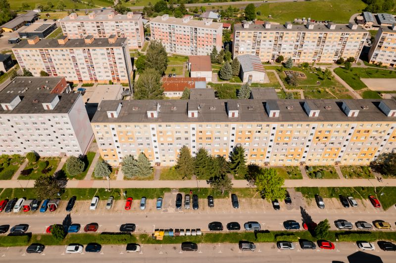 A top-down view of a row of apartment buildings on 9th May Street in Brezno with a parking lot.