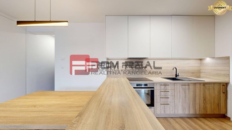 A kitchen in a 3-room apartment with a wooden decor floor and modern lighting.