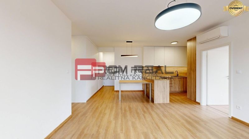 A kitchen with white cabinets and a wood-patterned floor in a 3-room apartment.