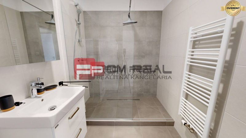 A bathroom with a shower and a sink in a 3-room apartment.