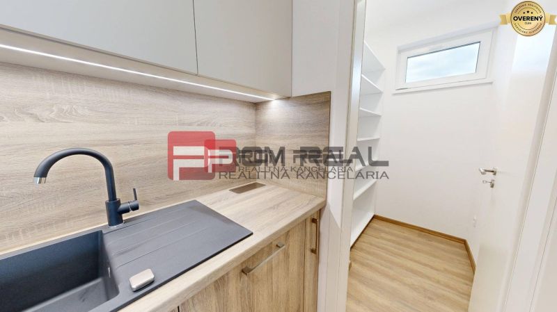 A kitchen in a 3-room apartment with a sink and a built-in wardrobe. Floor with wood decor.