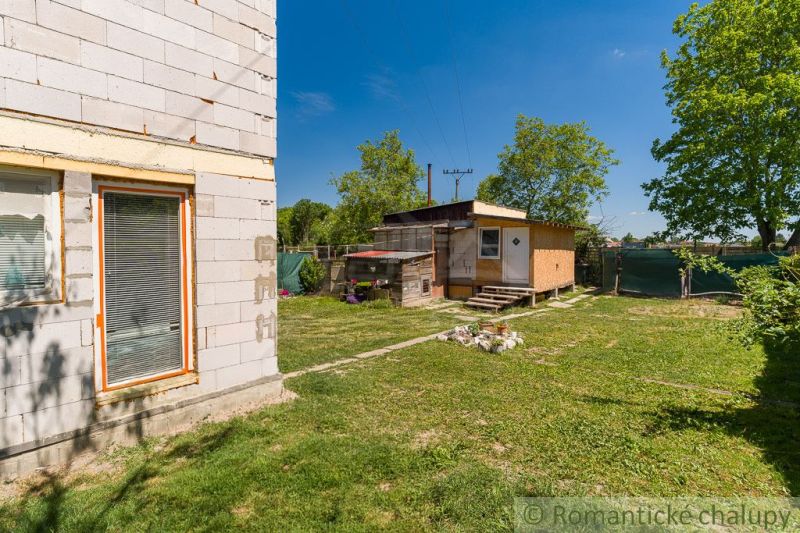 A garden cottage in Bernolákovo, surrounded by greenery and blue skies.