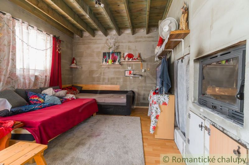 A room in a cottage with a sofa, a tiled stove, and a wooden decor floor, cozy atmosphere.