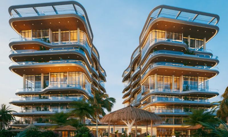 Design apartment buildings with glass facades in Paje surrounded by tropical vegetation.