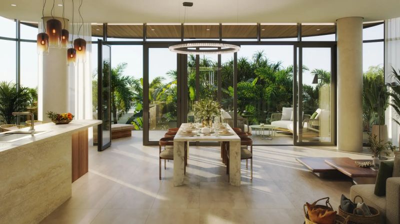 Modern dining room with luxurious table setting, view of the terrace, and wooden decor flooring.