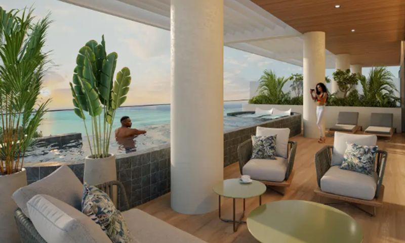 Terrace with loungers, a pool, a sea view, and a wooden decor floor in Paje.