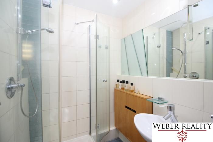A bathroom in a 3-room apartment with a shower corner and a mirrored wall.