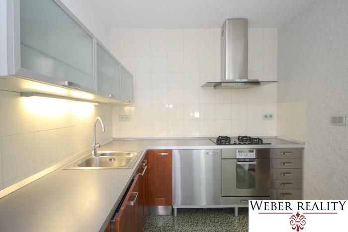 A kitchen in a 3-room apartment with stainless steel equipment and a laminate countertop.