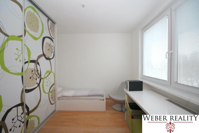 Children's room in a 3-room apartment with a wooden decor floor and a built-in wardrobe.