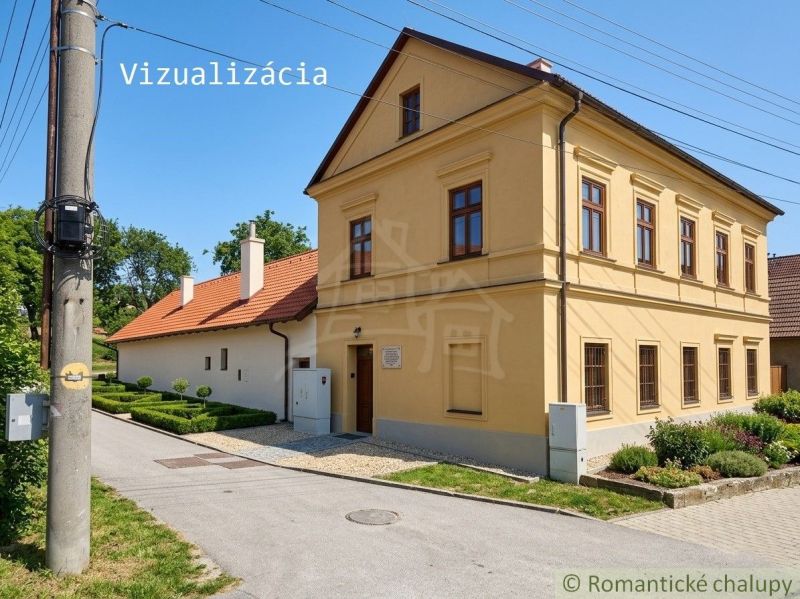 A family house in Klátova Nová Ves with a landscaped garden and a historic facade.