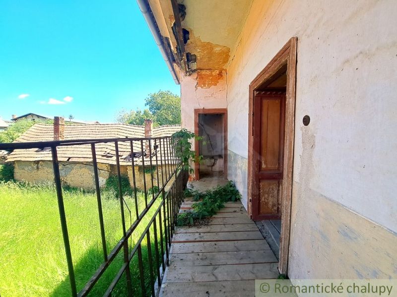 In Klátova Nová Ves, a balcony of a family house with a view of the lawn and roofs.