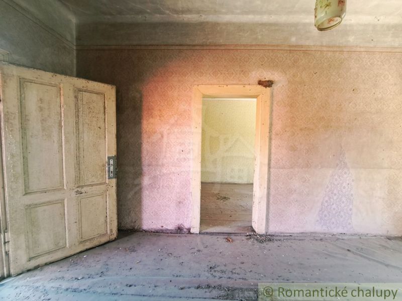 Original room with worn walls and doors in a family house.