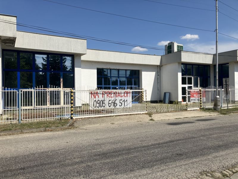 Commercial premises on 1. mája Street in Hurbanovo, with three large windows and a gate.